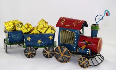 Toy steam train with wagons full of presents and gifts