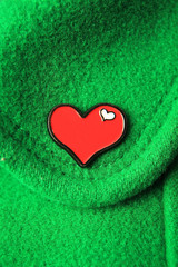 Heart on green fabric.