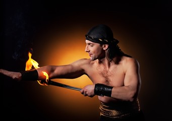 Handsome men performing fire show