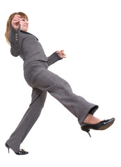 A young woman smartly dressed making a big step