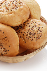 Buns with sesame in a woven basket