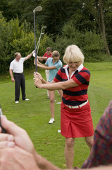 Golfschüler mit Lehrer