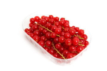 Plastic cup with red berries over white background