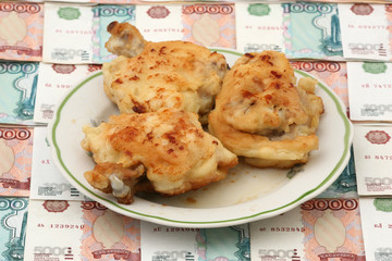 Chicken in a plate against paper money