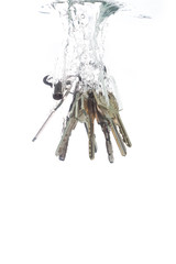 A key chain falling into clear water