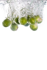 Brussels sprouts water falling into clear water