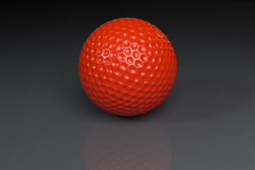 Red golfball on gray slightly reflective background