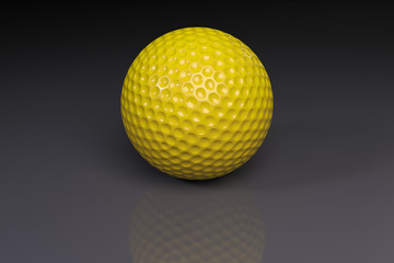 Yellow golfball on gray slightly reflective background