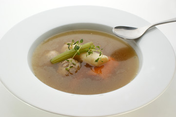 delicious vegetable soup in a white bowl with a spoon