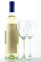 Bottle of white wine and empty wine glasses