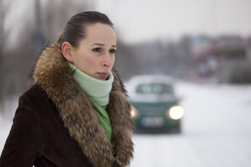 woman in coat on the road