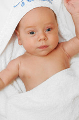 A cute 2 months old baby boy in a towel