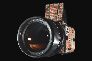 Medium format photo camera isolated on black.