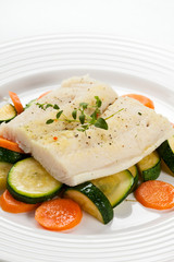 Boiled fish fillet with vegetables