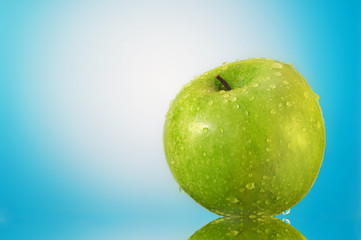 Green apple with water droplets