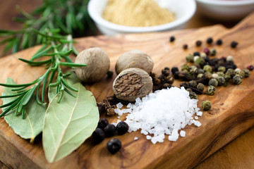 Spices and sea salt on rustic wooden background