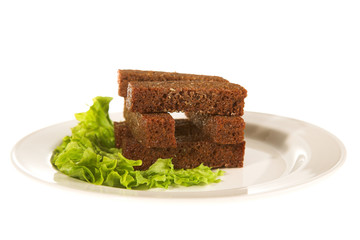 toasted bread with lettuce leaf on white