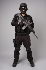 SWAT police officer with assault gun.
