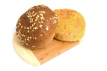 Two healthy buns on wooden board over white background