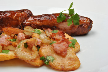 roasted potato with sausage on a white plate
