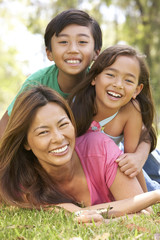 Mother And Children Enjoying Day In Park