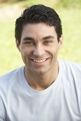 Portrait Of Young Man Sitting In Park