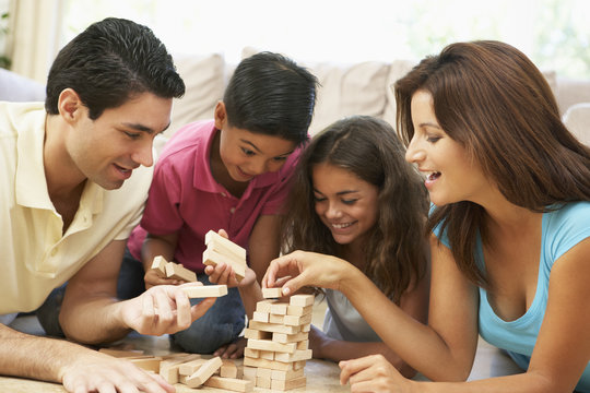 Family Playing Game Together At Home