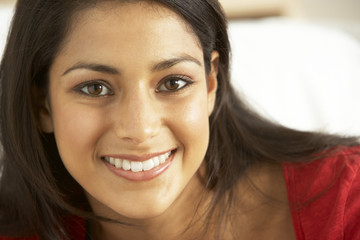 Portrait of young woman sitting on sofa