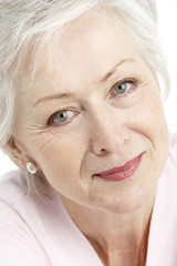 Studio Portrait Of Smiling Senior Woman