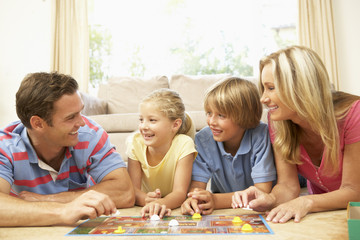 Fototapeta premium Family Playing Board Game At Home