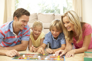 Naklejka premium Family Playing Board Game At Home