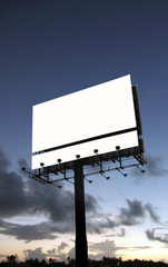 A blank billboard with a dramatic sunset background