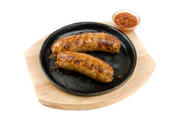 sausages at pan with sauce