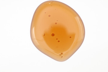 A drop of Vitamin E on a white background
