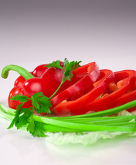 Sliced red ripe fresh pepper on bok choy leafs
