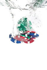 Poker chips falling into the clear water