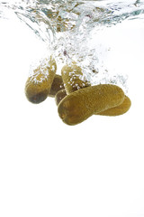 Pickles falling into the clear water
