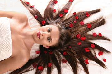 Beautiful woman with red flower petals