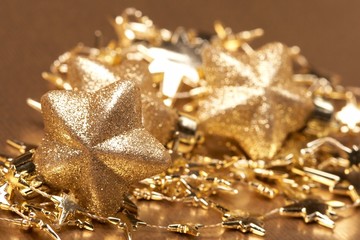 Christmas gold stars on the gold background