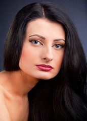 Obraz premium Beautiful young woman face over dark background