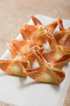 Crab Rangoons on white paper