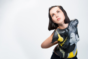 caucasian young girl with body art painting looking up isolated