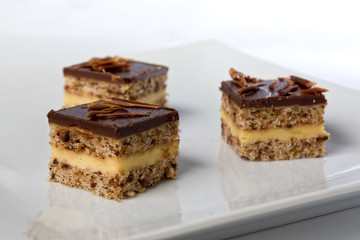 pieces of a chocolate cake on a plate in shallow depth of field
