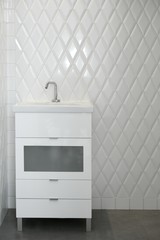 toilet sink in a white room diamond shape tiles