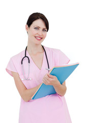 Charming female nurse writing on a clipboard