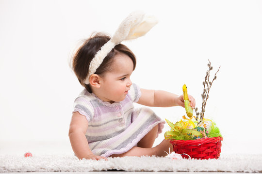 Baby playing with easter basket