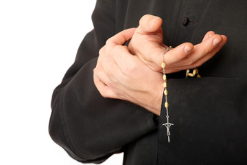 Priest's hands with rosary