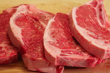 Freshly cut strip steaks ready to grill