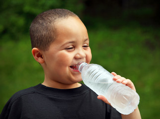 Smiling boy drinking