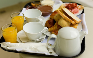 Fototapeta na wymiar Tasty breakfast for two, closeup of the breakfast tray, focus is